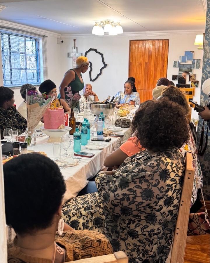 Guests sharing a celebration meal inside Café Riza in New Brighton