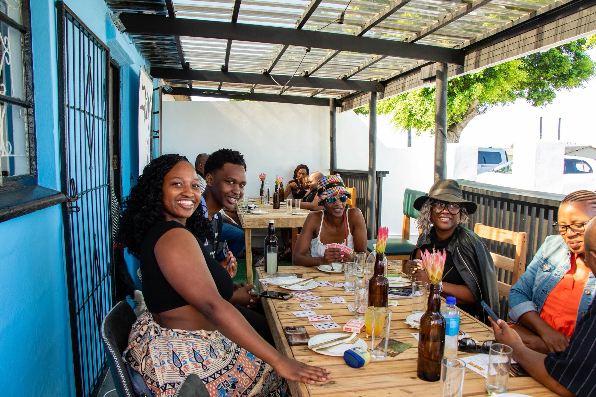 Guests enjoying food and games on the Café Riza patio in New Brighton